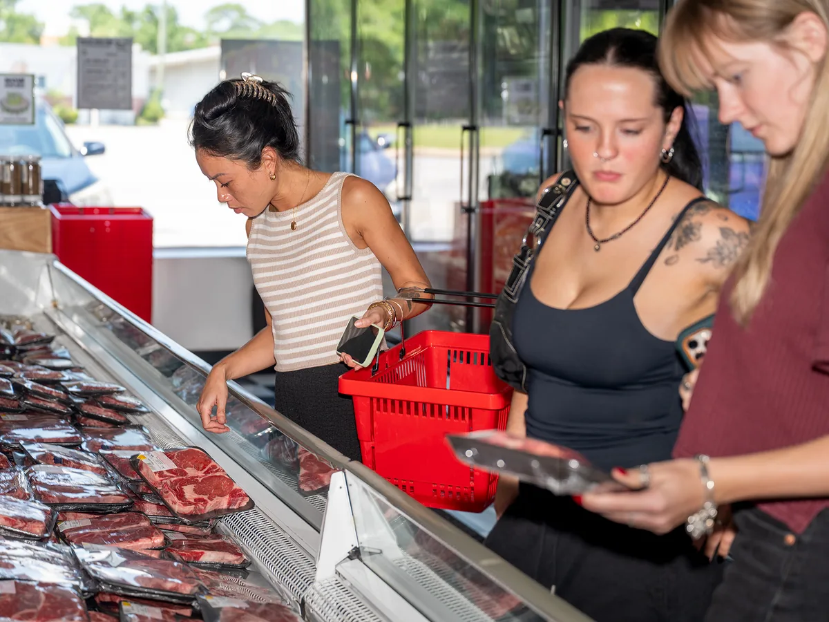 Customers choosing cuts at the meat case