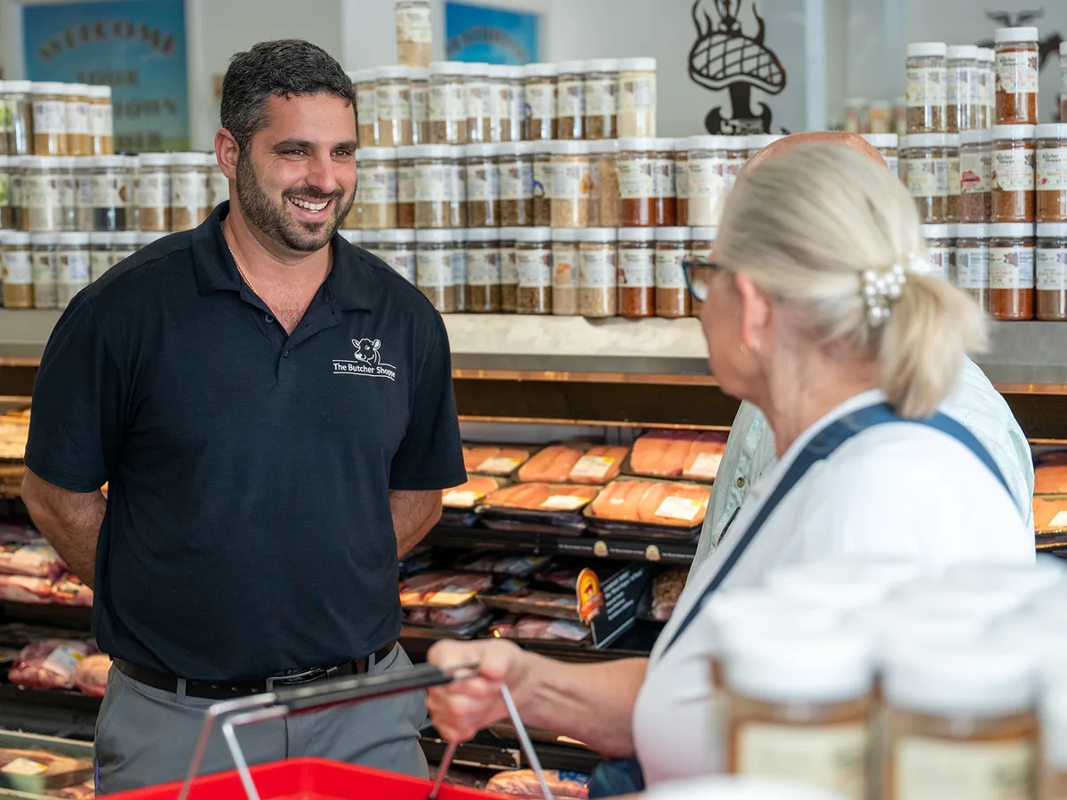 A staff member helping customers at the case