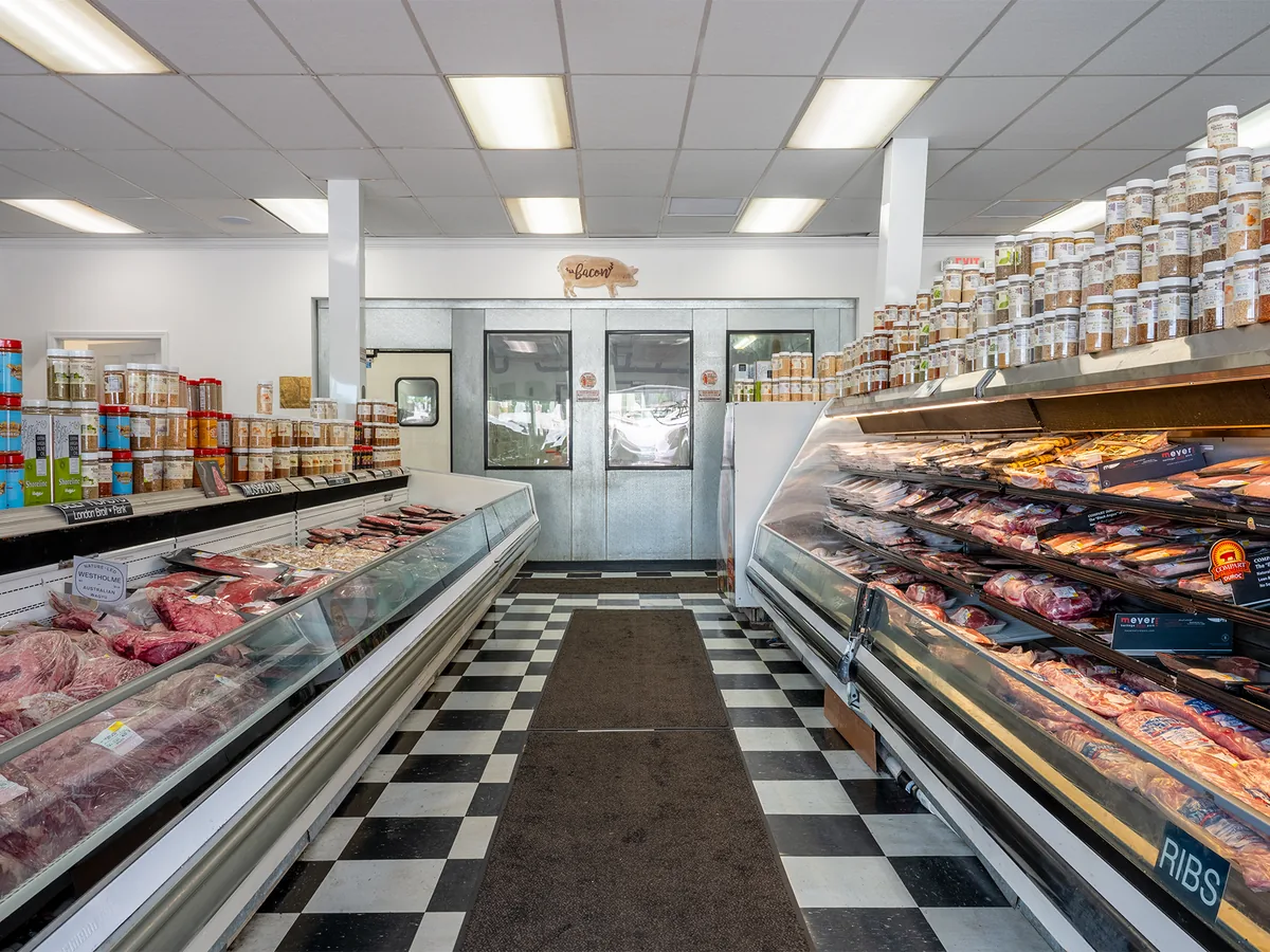 The main aisle of meat cases inside The Butcher Shoppe