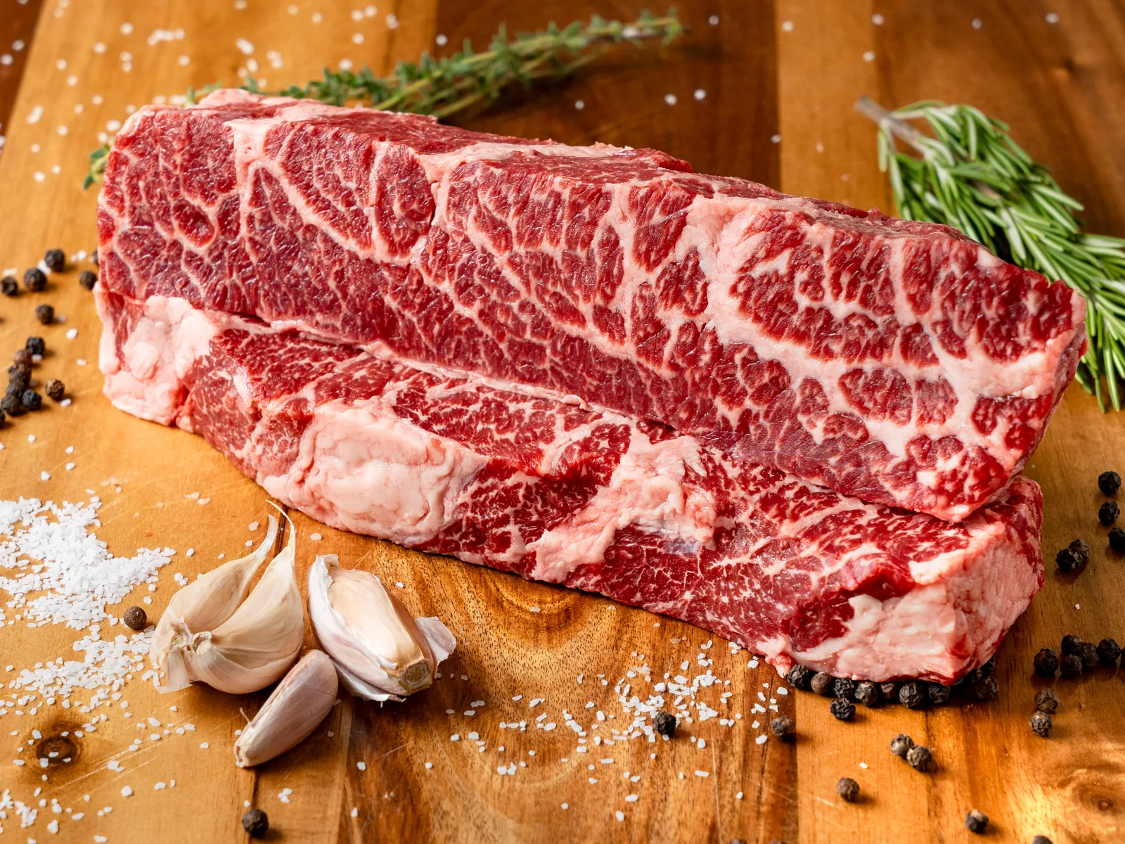 Fresh strip steaks ready for the grill